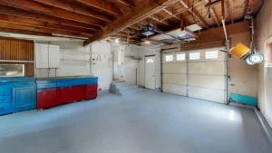 A ceiling-mounted garage door opener motor unit with its light cover