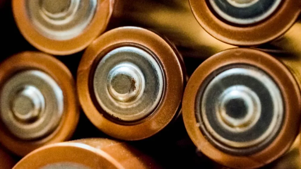 A small pile of AA batteries on a table