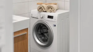 A front-load washing machine in a bright home laundry room