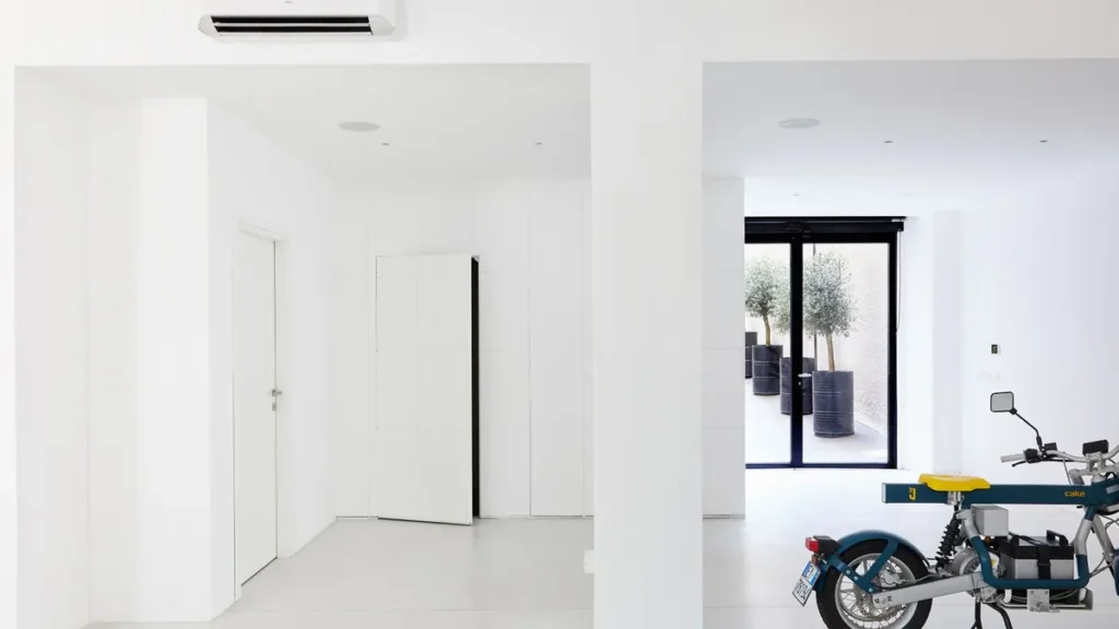 Garage door opener motor unit mounted to the ceiling of a home garage