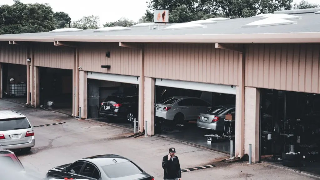 A garage door remote clipped to a car sun visor