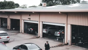 A garage door remote clipped to a car sun visor